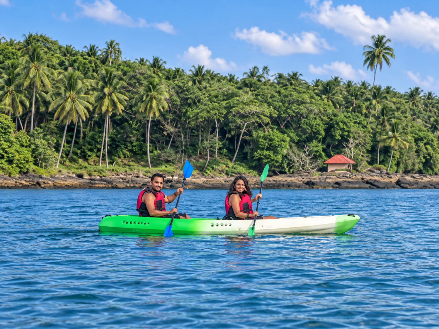 Enhanced image of two paddlers in a green-and-white tandem kayak wearing lifejackets